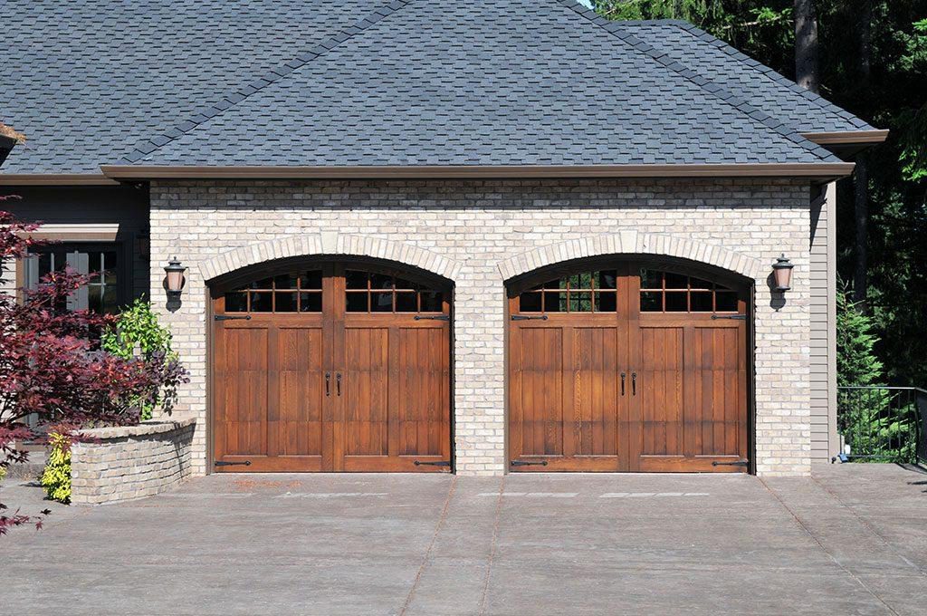 Front view of side hinged wood finish garage doors