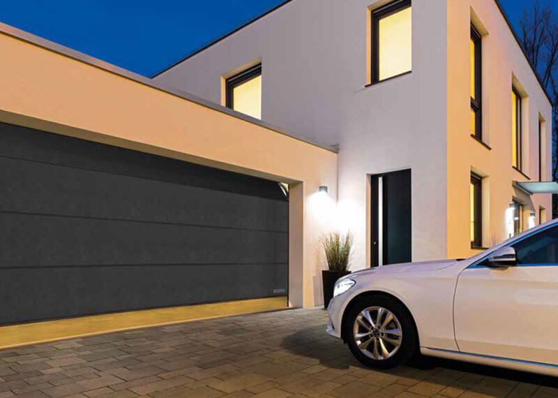 Modern Hormann Sectional Garage Door With White Mercedes Parked